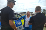 Jackie speaking with two police officers